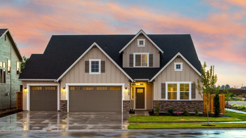 brown and gray painted house in front of road